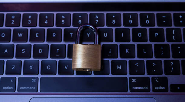 Padlock in keyboard illustrating online security concept stock photo