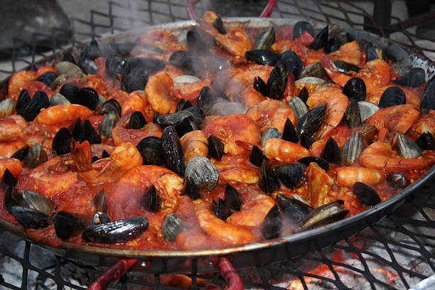 Paella Steaming on Outdoor Grill stock photo