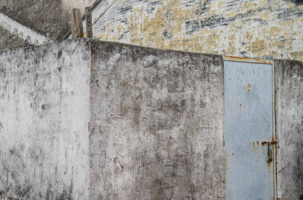 pain off walls in a gray and yellow house in macau stock photo