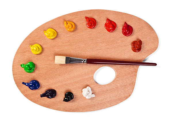 Paint palette with clean brush and fresh paints Photo of a wooden artists palette loaded with various colour paints and brush, isolated on a white background with clipping path. artist's palette stock pictures, royalty-free photos & images