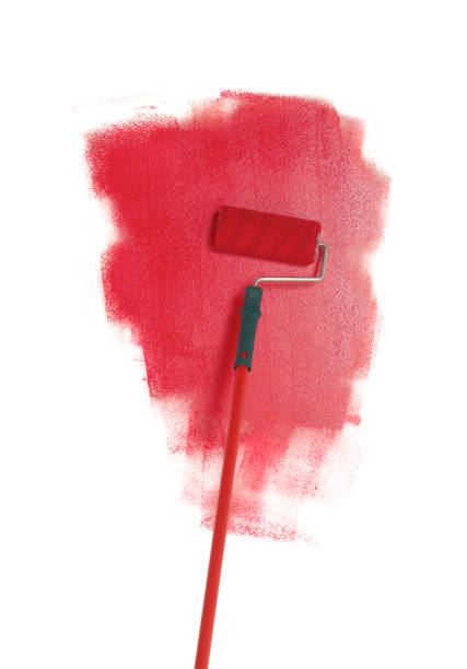 Paint roller on wall stock photo
