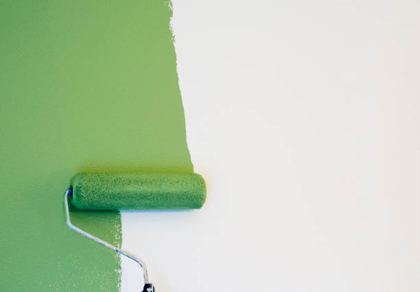 Paint Roller Painting a Wall stock photo