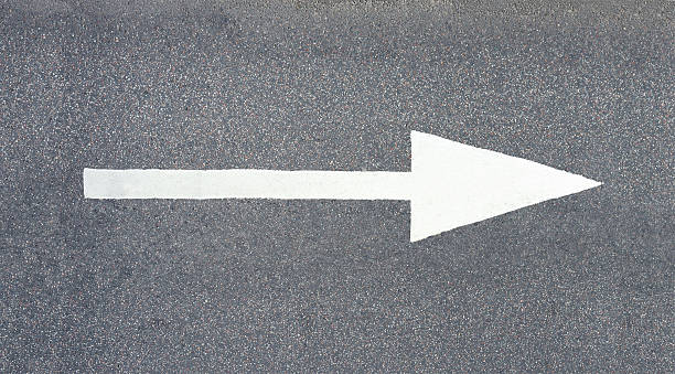 Painted arrow on asphalt stock photo