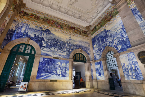 Painted ceramic tileworks on the walls of Main hall of Sao Bento Railway Station in Porto, Portugal stock photo