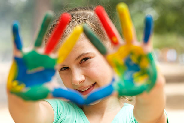 Painted hands Ten year old girl with hands painted in colorful paints ready for hand prints art and craft product stock pictures, royalty-free photos & images