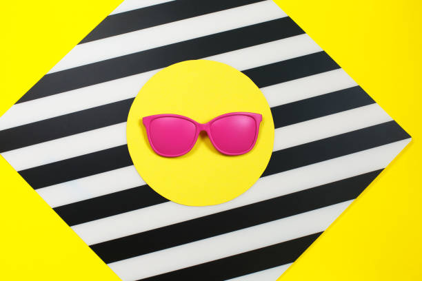 Painted pink Fashion sunglasses on colorful background. stock photo