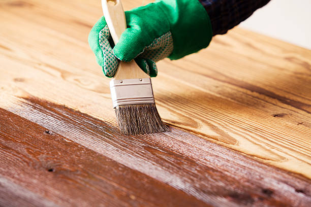 Painting and wood preservation Painting and wood maintenance oil-wax deck stock pictures, royalty-free photos & images
