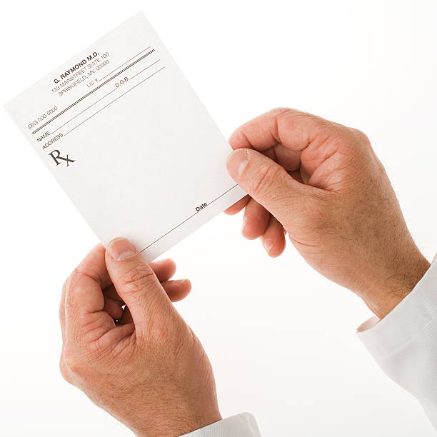 Pair of hands holding an empty doctor's prescription sheet stock photo