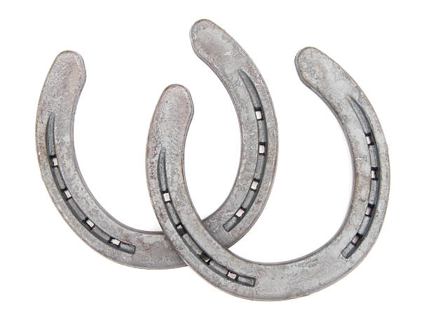 Pair of horse shoes on white background A pair of horseshoes. horseshoe stock pictures, royalty-free photos & images