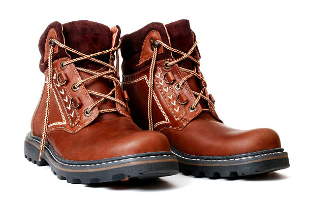 Pair of new brown leather boots with fabric trim stock photo