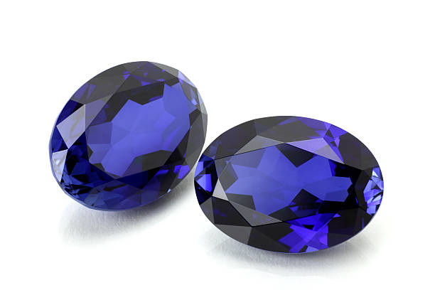 Pair of Sapphire or Tanzanite. A Pair of Oval Sapphire or Tanzanite on White. zoisite photos stock pictures, royalty-free photos & images