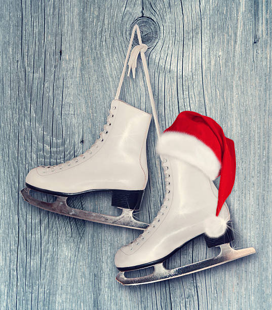 Pair of White Ice Skates and Santa Claus hat stock photo