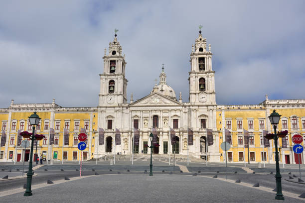 Palace of Mafra Portugal Mafra, Portugal - June 01, 2017: Facade of the Basilica at the Palace of Mafra Portugal a famous royal palace built in the 18th Century mafraq stock pictures, royalty-free photos & images