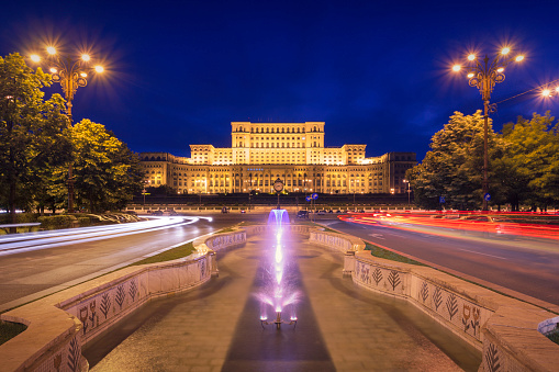 Evening view of the Palace of the Parliament, also known as the People's House, the seat of the Parliament of Romania, seen from Unirii Boulevard. The building was completed in 1997 and is the third largest building in the world.