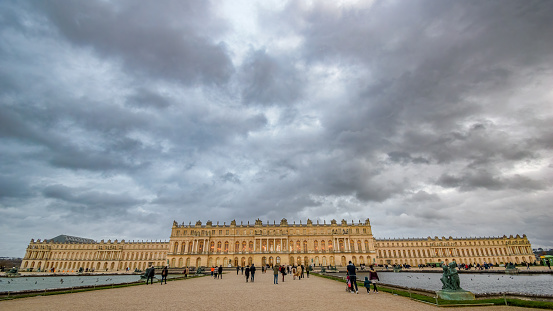 Palace of Versailles, France  - January 2, 2022: The Palace of Versailles is a former royal residence located in Versailles, about 12 miles (19 km) west of Paris, France. The palace is owned by the French Republic and has since 1995 been managed, under the direction of the French Ministry of Culture, by the Public Establishment of the Palace, Museum and National Estate of Versailles. 15,000,000 people visit the Palace, Park, or Gardens of Versailles every year, making it one of the most popular tourist attractions in the world.