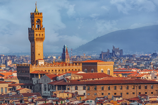 Beautiful Ponte Vecchio, Vasari Corridor and Uffizi Gallery are mirrored in the river Arno, Florence. Tuscany, Italy. Travel destination.