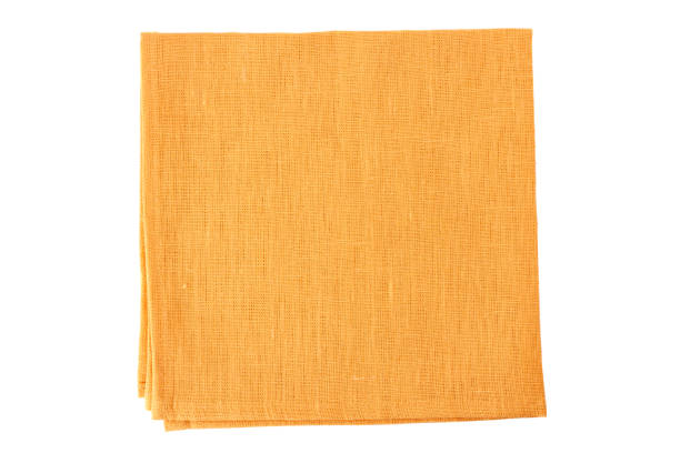 tovagliolo tessile arancione pallido su bianco - tovaglietta foto e immagini stock