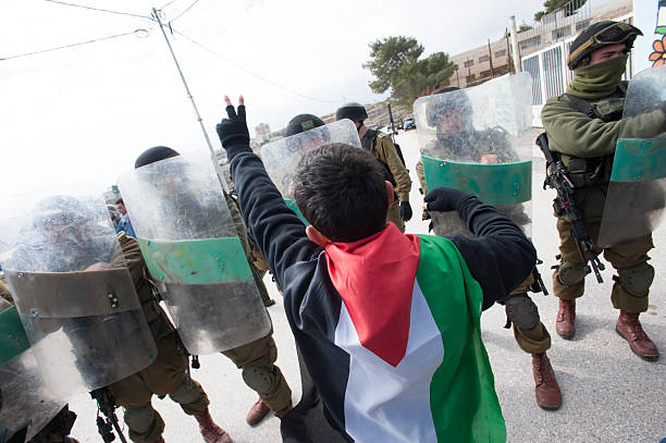 Palestinian protest and Israeli soldiers stock photo
