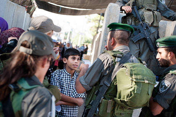 Palestinians at Israeli military checkpoint stock photo