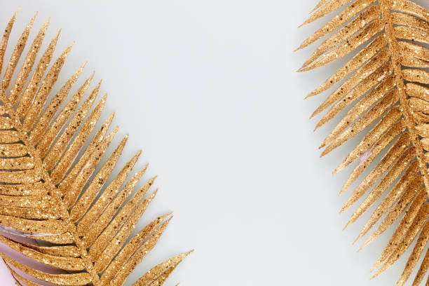 Palm gold leaf on blue background. Palm leaf, Flat lay and top view. stock photo