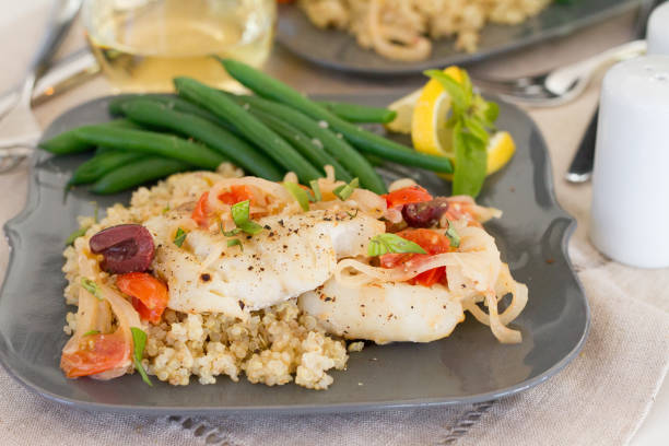 Pan Seared Cod with Tomatoes, Onions, and Olives stock photo