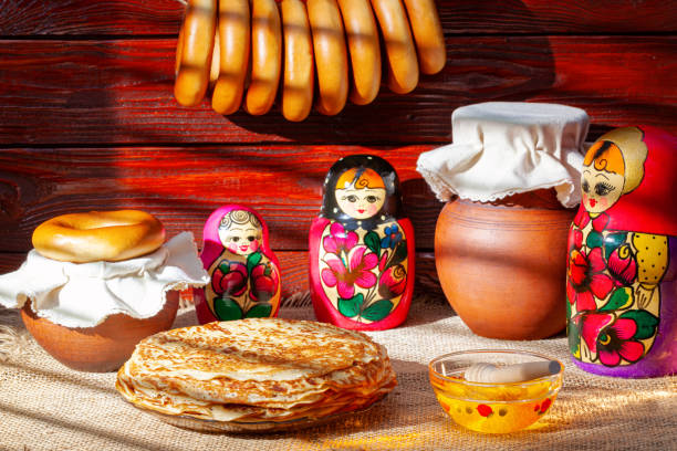 Pancakes with honey and matryoshka dolls are must-have accessories for Maslenitsa week, Russia stock photo