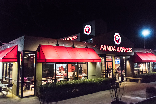 Davis, California, USA- January 27, 2017: Night View of a Panda Express Restaurant at East Cowell Boulevard in Davis, CA. Panda Express is a fast food casual restaurant chain which serves American Chinese cuisine. Panda Express has over 1,900 restaurants, located in USA, Canada, Mexico, Korea, and the United Arab Emirates.