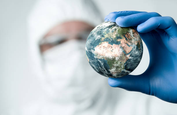 Pandemic concept Pandemic concept, close up of scientist holdnig and analyzing planet earth climate change stock pictures, royalty-free photos & images