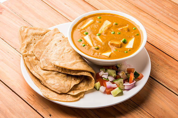 paneer butter masala with chapati / roti / paratha paneer butter masala with chapati / roti / paratha / fulka / indian bread and green salad chapatti stock pictures, royalty-free photos & images