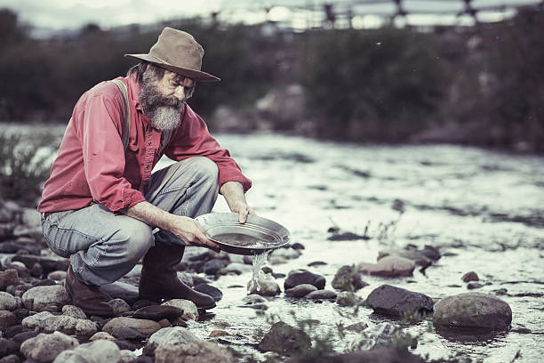 Panning for Gold Old man panning for Gold. 20th century style stock pictures, royalty-free photos & images