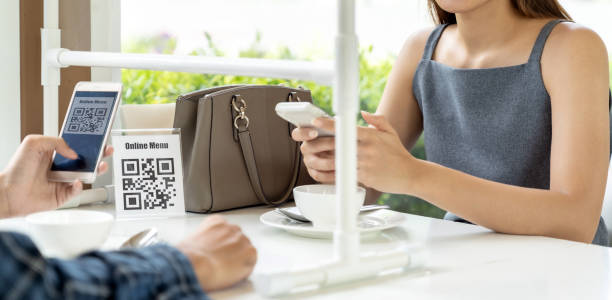 Panorama Asian customer scanning QR code for online menu un new normal restaurant Panorama Asian customers scan QR code online menu. Customers sat on social distancing table for new normal lifestyle in restaurant after coronavirus covid-19 pandemic. restaurant  couple stock pictures, royalty-free photos & images