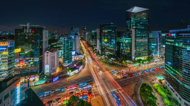 Panorama of Gangnam City at Night Seoul, South Korea Panorama aerial view of famous crowded Crossing at Downtown Gangnam Station at Night with motion blured traffic lights and surrounding modern skyscrapers. Gangnam District, Seoul, South Korea, Asia. south korea stock pictures, royalty-free photos & images