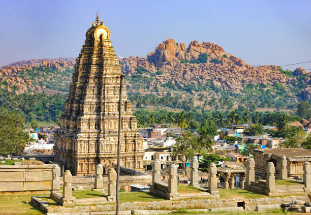 Panorama of Hampi, view of the Virupaksha temple Virupaksha Temple, located in the ruins of ancient city Vijayanagar at Hampi, India. Landscape with unique mountain formation, tropical nature on the horizon and old hindu temple. hampi stock pictures, royalty-free photos & images