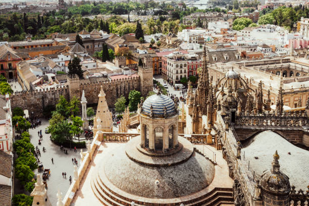 Panorama of Seville city from the bell tower of La Giralda Cathedral. Seville, Andalusia, Spain - April 10 2019: Panorama of Seville city from the bell tower of La Giralda Cathedral. Historic downtown square Plaza de Virgen de los Reyes, Seville, Andalusia, Spain. seville cathedral stock pictures, royalty-free photos & images