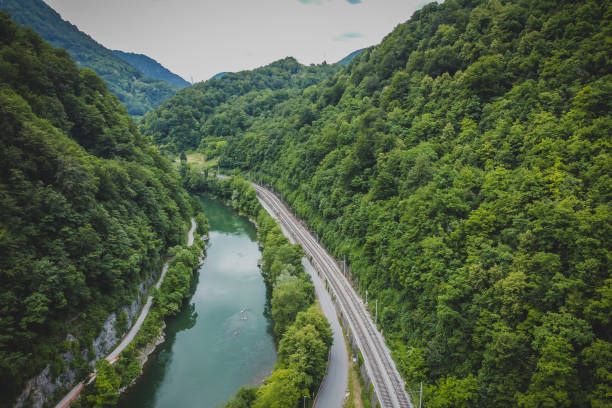 Panorama of tight river valley with cramped railway line and road next to a wide green Sava river close to Hrastnik and Trbovlje. stock photo