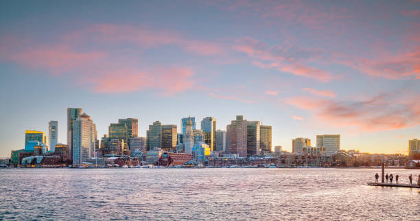 Panorama view of Boston skyline with skyscrapers at twilight in United States Panorama view of Boston skyline with skyscrapers over water at twilight in United States waterfront photos stock pictures, royalty-free photos & images
