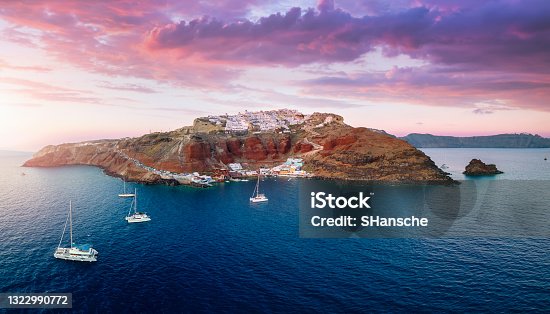 istock Panoramic aerial view to the villages of Oia and Ammoudi during sunset time 1322990772