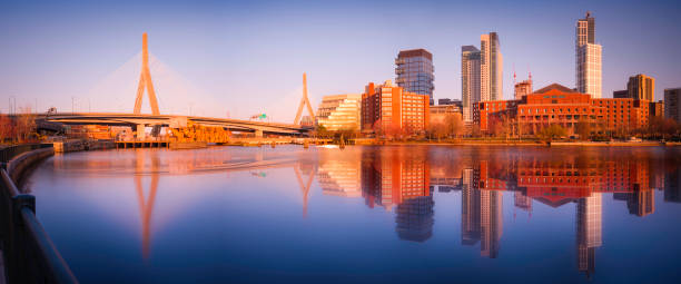 Panoramic Boston Sunset Cityscape, Skyline, and Zakim Bridge with Reflections on Charles River. Tranquil Boston Scenery from North Point Park in Springtime. stock photo