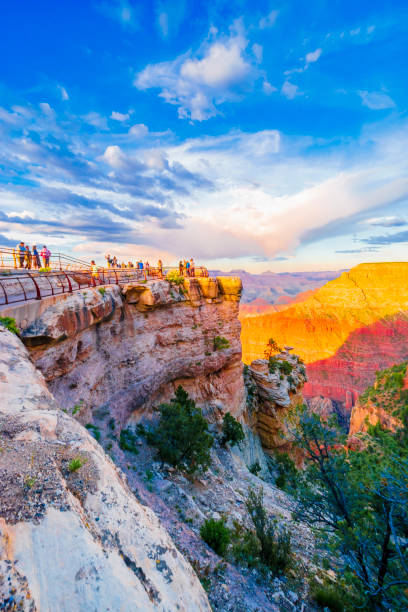 Panoramic image of the colorful Sunset on the Grand Canyon in Grand Canyon National Park from the south rim part,Arizona,USA, on a sunny cloudy day with blue sky The Grand Canyon is a steep-sided canyon carved by the Colorado River in Arizona, United States. south rim stock pictures, royalty-free photos & images