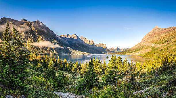 Panoramic landscape view of Glacier NP mountain range and lake stock photo