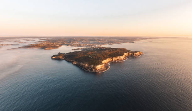 XXL panoramic sunrise aerial drone view of North Head, a headland in Manly and part of Sydney Harbour National Park in Sydney, New South Wales, Australia. Manly and Northern Beaches in background. stock photo