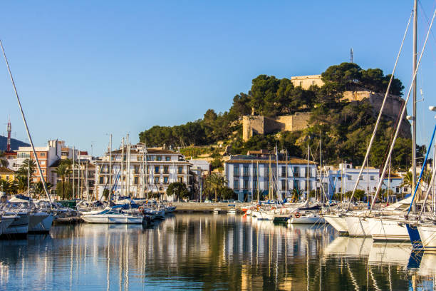 Panoramic view of Denia Port Marina promenade and Castle Panoramic view of Denia Port Marina promenade and Castle costa blanca stock pictures, royalty-free photos & images