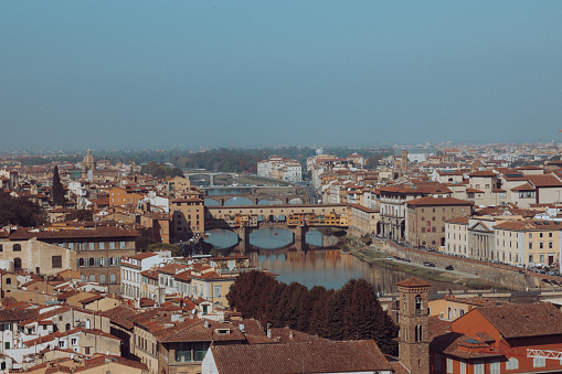 Aerial and panoramic view of Arno River, Duomo Cathedral and Ponte Vecchio and cityscape during a beautiful sunny day with clear sky, Florence, Italy. High Resolution. XXL