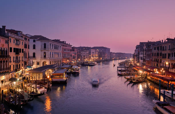 Venice, Italy - February 18, 2020: Panoramic view of Grand canal from Rialto Bridge during sunset.(Ponte di Rialto) is one of the main tourist attractions of Venice. stock photo