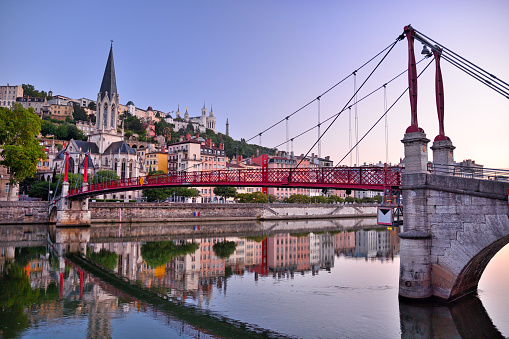 Panoramic view of Lyon with Saint Georges footbridge over Saone river at sunset, France