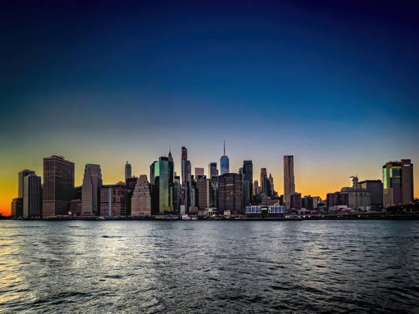 Panoramic view of Manhattan skyline during subset in New York City, NY stock photo