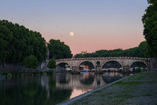 Panoramic view of Ponte Sisto, with full moon. stock photo