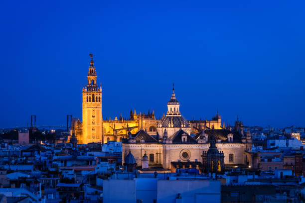 panoramic view of Seville skyline with Giralda tower at background, Spain historical Giralda tower view from old town seville cathedral stock pictures, royalty-free photos & images