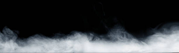 Panoramic view of the abstract fog or smoke move on black background. White cloudiness, mist or smog background. stock photo
