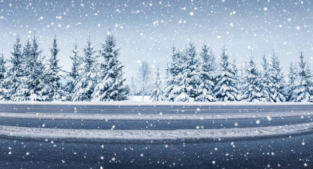 Panoramic view of the beautiful country road in winter in snowfall. stock photo